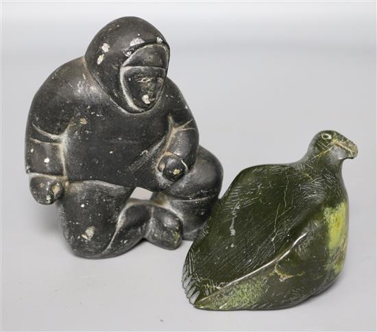 An Inuit soapstone carving of a kneeling figure and a stylised hardstone carving of a walrus